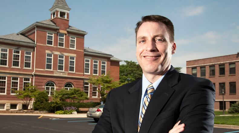 Dr. Thomas White, Cedarville University President, with Founders Hall.