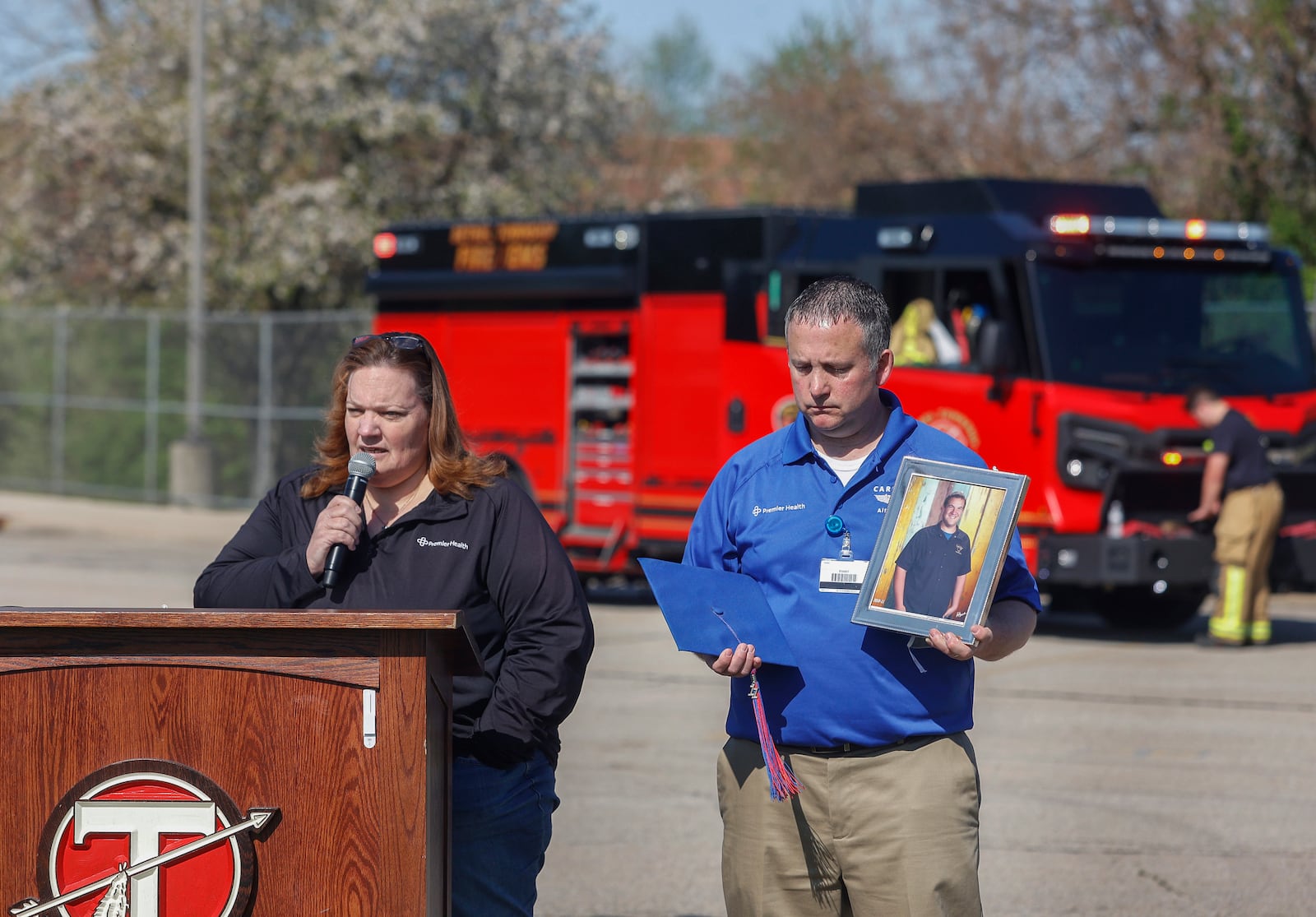 Laura Seger, left, of Pleasant Hill, talks about her son, Joey, who was killed at 18 by a driver under the influence to warn teenagers about the dangers of impaired driving next to Michael Moyer, left, flight nurse of Careflight Air & Mobile, during a mock crash simulation on Wednesday, April 23, 2025, at Tecumseh High School. JOSEPH COOKE/STAFF

