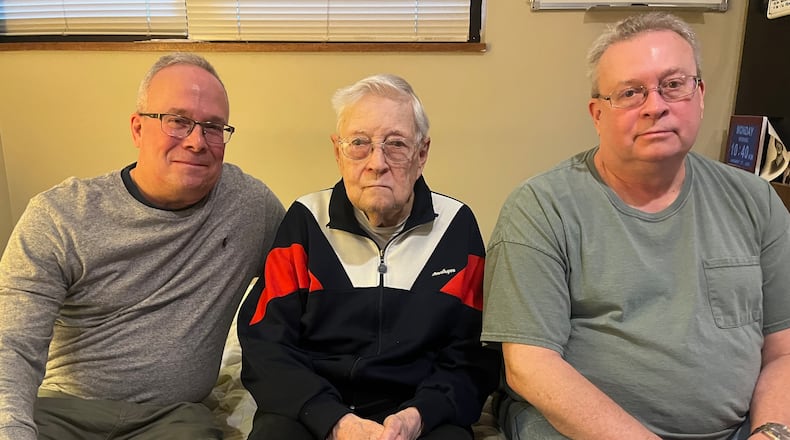 Former Journal Herald and Dayton Daily News sports writer Jim Zofkie, center, poses for a photo with his sons Tim, left, and Mike, on Monday, Jan. 27, 2025, in Centerville. David Jablonski/Staff