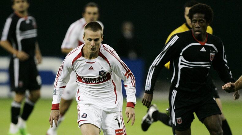 Chicago Fire’s Chris Rolfe, left, advances the ball past a D.C. United defender during the first half of a soccer game, Thursday, Nov. 1, 2007, in Washington. (AP Photo/Haraz N. Ghanbari)