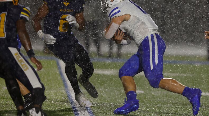 Springboro's Mattias Brunicardi carries the ball between Springfield's Rashad Walker Cherry and Taj Powell. BILL LACKEY/STAFF