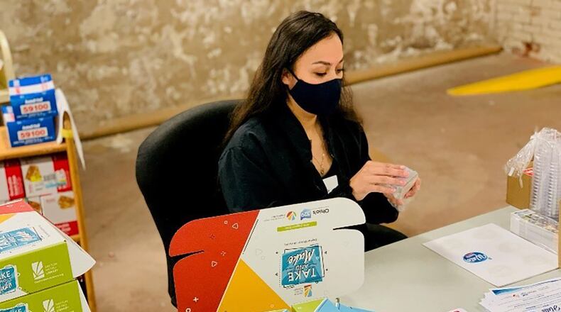 Volunteers from the National Air and Space Intelligence Center on Wright-Patterson Air Force Base join three Dayton Metro Library workers to build “Take and Make” kits during a two-day project April 23-24. “The Science of Water.” Space Force Spc. 3 Monica Zamarripa assembles a kit. The NASIC volunteers put together a total of 500 kits to support Dayton Metro Library’s May educational theme, “The Science of Water.” CONTRIBUTED PHOTO