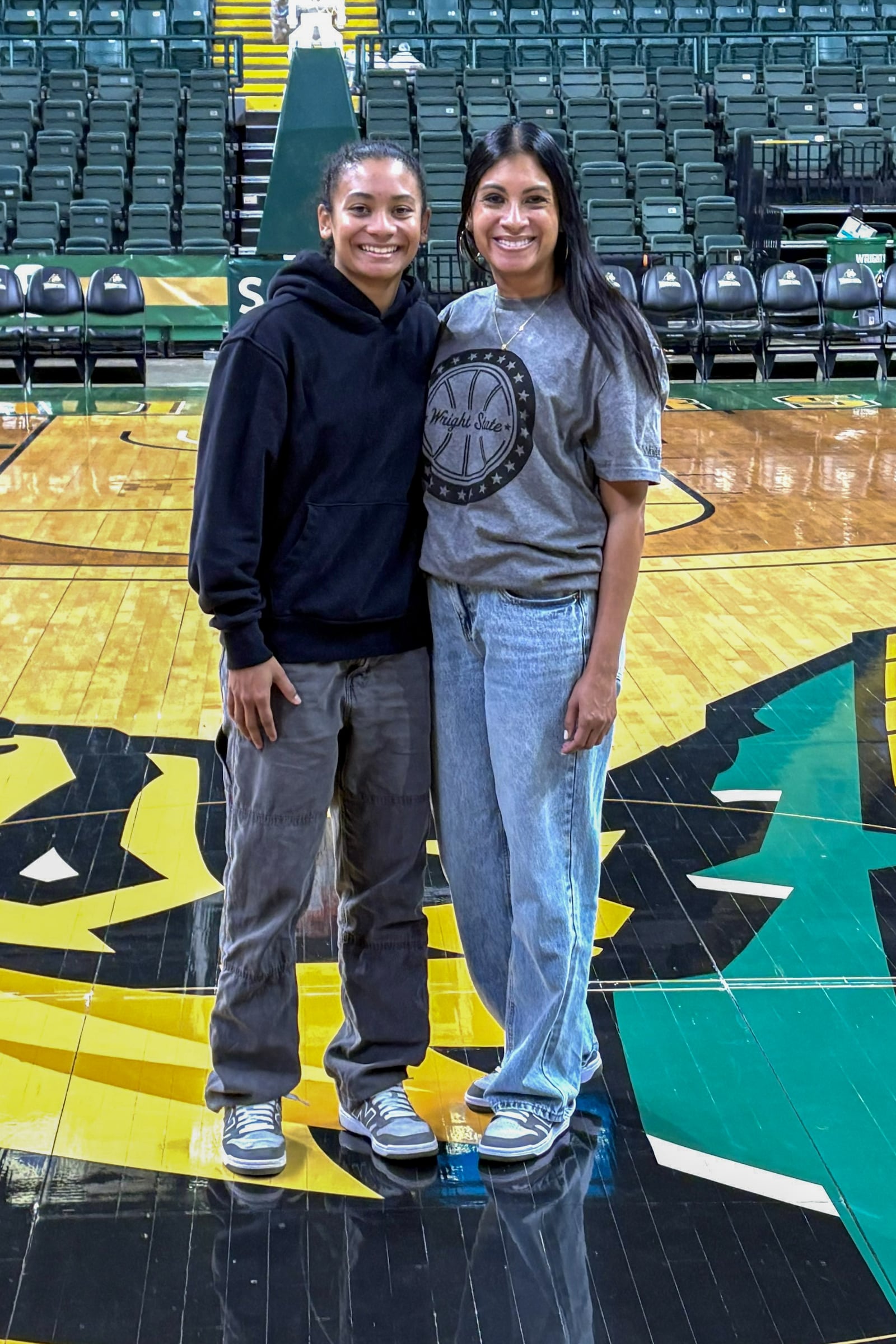 Wright State University guard Breezie Williams and her mom Brandi on the Nutter Center court after Wednesday's game against Bellarmine. TOM ARCHDEACON / CONTRIBUTED PHOTO
