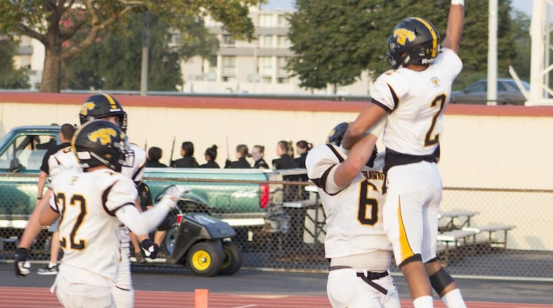 Shawnee wide receiver Hayden Lawhorn and lineman Eli Wade celebrate Lawhorn’s 28-yard touchdown catch from Robie Glass in the second quarter of Saturday night’s game against Thurgood Marshall at Welcome Stadium. JEFF GILBERT / CONTRIBUTED
