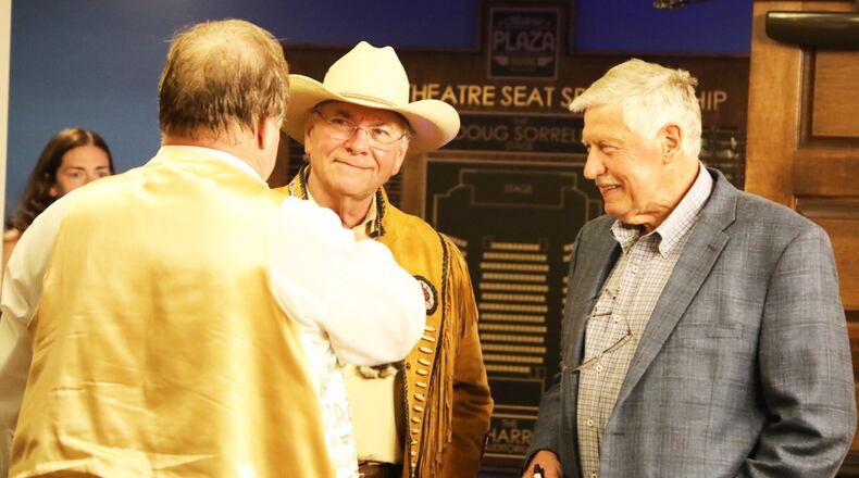 Joe Harrison (right) converses with Doug Sorrell (left) and Mike Nolan (center) during a Plaza Gala event at the Historic Plaza Theatre in 2019. Sorrell, one of the theater's emeritus board of directors, said Harrison purchased the building as part of his efforts to help Miamisburg revitalize its downtown.