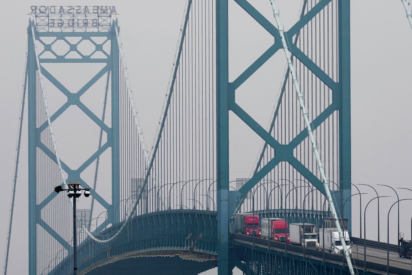 FILE - Box trucks cross the Ambassador Bridge entering the United States from Canada, as seen from Detroit, Feb. 3, 2025. (AP Photo/Paul Sancya)