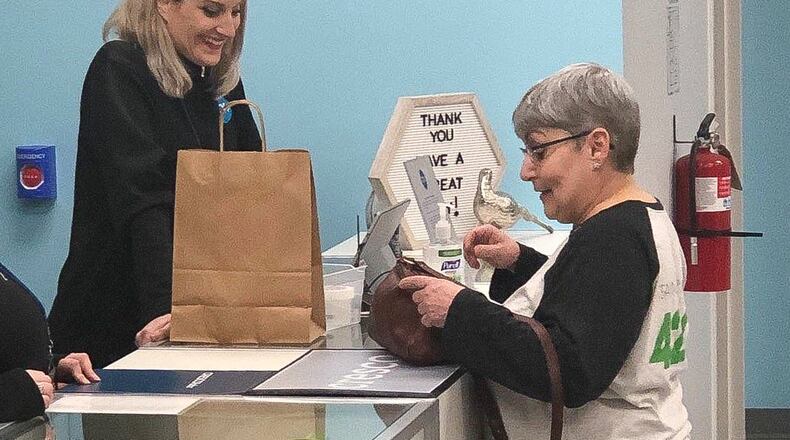 Joan Caleodis, right, of Martins Ferry was the first to purchase legal medical marijuana at the CY+ dispensary in Wintersville on Wednesday, the first day the medicine went on sale in Ohio. CONTRIBUTED