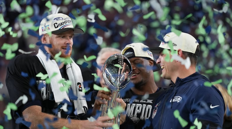 Seattle Seahawks head coach Mike Macdonald and quarterback Sam Darnold, left, hold the Lombardi Trophy after a win over the New England Patriots in the NFL Super Bowl 60 football game Sunday, Feb. 8, 2026, in Santa Clara, Calif. (AP Photo/Matt Slocum)