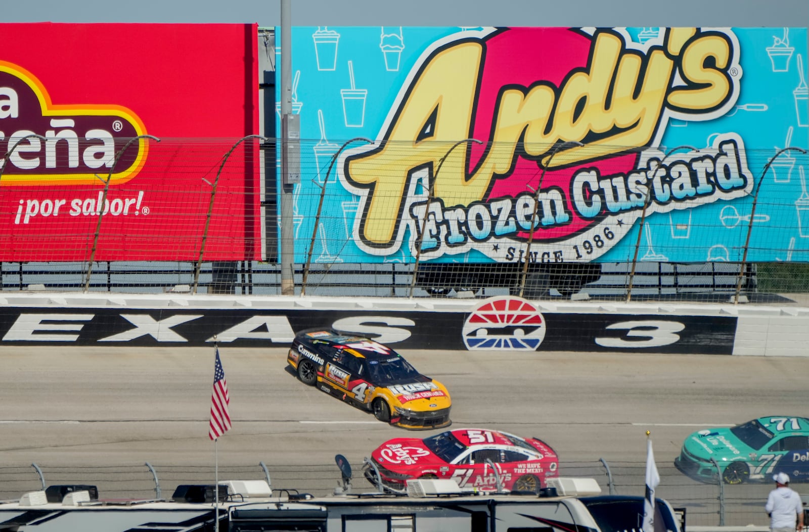 Noah Gragson (4) crashes in Turn 3 as Cody Ware (51) and Michael McDowell (71) pass him during a NASCAR Cup Series auto race at Texas Motor Speedway in Fort Worth, Texas, Sunday, May 4, 2025. (AP Photo/Larry Papke)