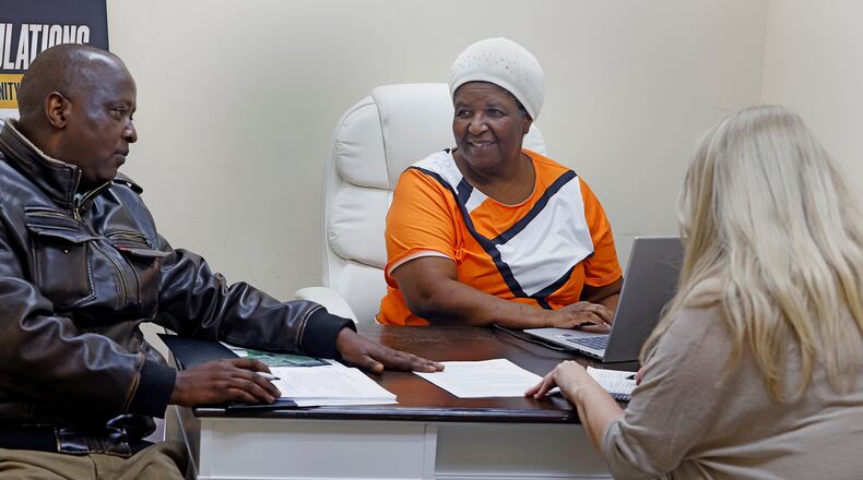 Catherine Bitwayiki, center, talks with her staff Friday, Feb. 28, 2025 at the Ahiska Turkish American Community Center. 
MARSHALL GORBY\STAFF