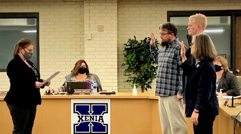 Newly elected Xenia Community Schools board members George Leightenheimer, Josh Day, and Mary Grech are sworn in on Monday.