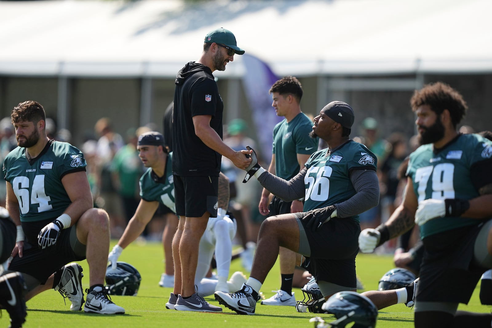 Philadelphia Eagles head coach Nick Sirianni greets Tyler Steen (56) during an NFL football training camp, Wednesday, July 23, 2025, in Philadelphia. (AP Photo/Matt Rourke)