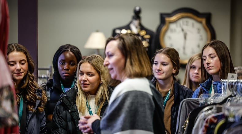 Students from eight area high schools listen to Dante Connell, director of development for Clothes That Work, discuss the nonprofit's business model in the boutique Friday Feb. 3, 2023. JIM NOELKER/STAFF