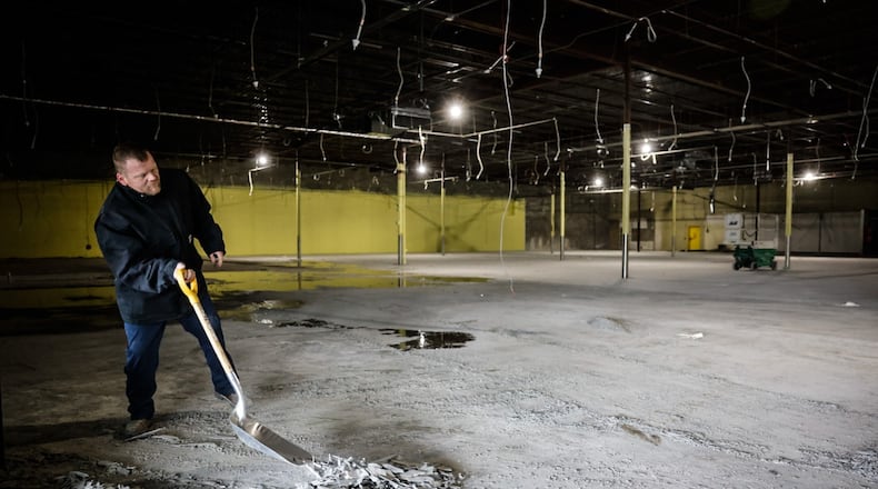 Mike Jung from Luts Construction replaces the flooring at the old Marc's on Whipp Road Friday January 5, 2024. The old store is being transformed into a trampoline park. JIM NOELKER/STAFF