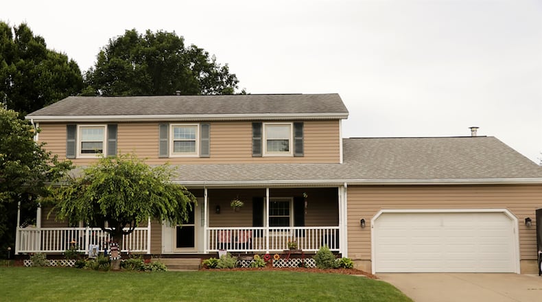 The vinyl-sided house has about 2,470 sq. ft. of living spaces plus a finished basement. A covered porch stretches across the front of the house, and the near half-acre lot has a deep back yard that is surrounded by a fence. CONTRIBUTED PHOTO BY KATHY TYLER