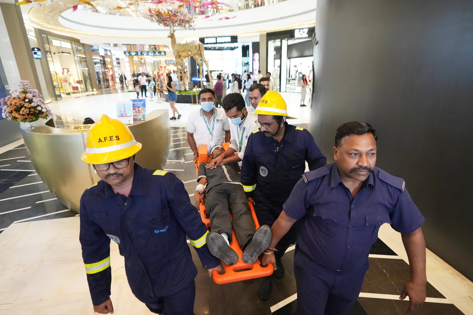 Fire brigade workers and paramedics participate in a security mock drill at a mall in Ahmedabad, India, Wednesday, May 7, 2025, amid rising fears of wider conflict following India's strikes in Pakistan. (AP Photo/Ajit Solanki)