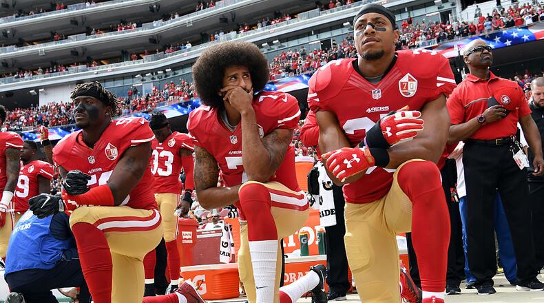 SANTA CLARA, CA - OCTOBER 02: (L-R) Eli Harold #58, Colin Kaepernick #7 and Eric Reid #35 of the San Francisco 49ers kneel on the sideline during the anthem prior to the game against the Dallas Cowboys at Levi’s Stadium on October 2, 2016 in Santa Clara, California. (Photo by Thearon W. Henderson/Getty Images)