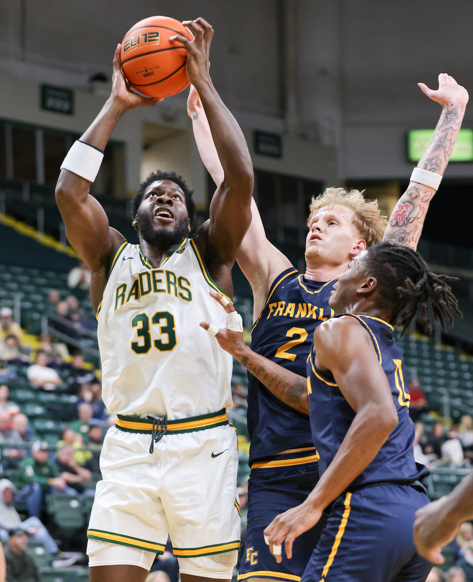 Wright State forward Michael Imariagbe shoots with pressure from Franklin College's Jesse Faires (right) and LeBron Bennie-Powell during a season opener on Monday, Nov. 3 at Ervin J. Nutter Center. Imariagbe led the squad with 13 points and had four rebounds in a little over 15 minutes of action in a 86-37 win. BRYANT BILLING/STAFF