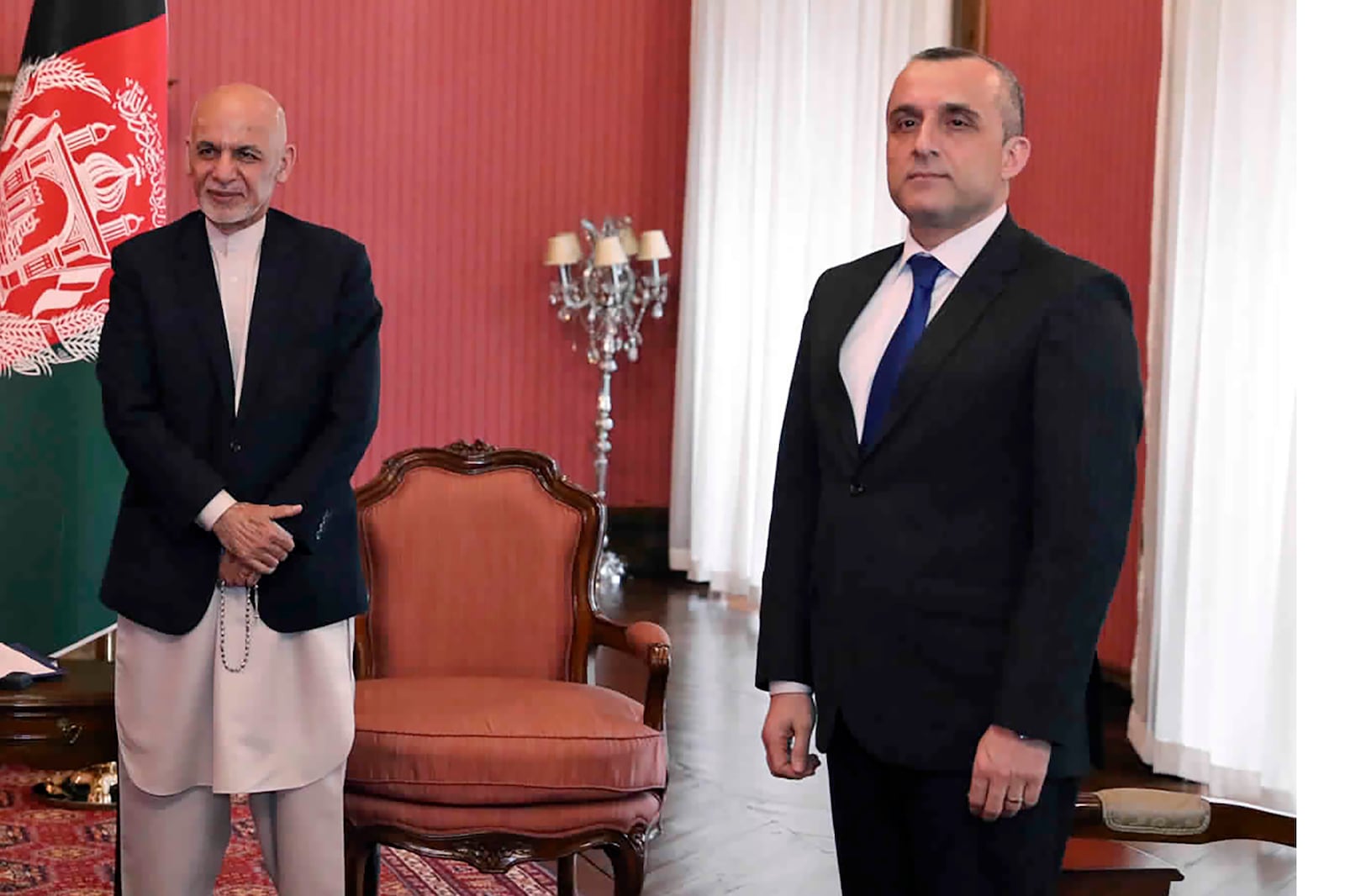 FILE - In this March 23, 2020, file photo, First Vice President Amrullah Saleh, right, and Afghan President Ashraf Ghani,left, attend a meeting with 
U.S. Secretary of State Mike Pompeo, at the Presidential Palace in Kabul. Afghan officials claimed a failed assassination attempt against Afghanistan's first vice president Saleh. Razwan Murad, a spokesman for the first vice president said Wednesday, Sept. 9, that the enemies of Afghanistan again tried to harm Saleh, but the vicious and terrorist attempt has failed and Saleh has survived. (Afghan Presidential Palace via AP, File)