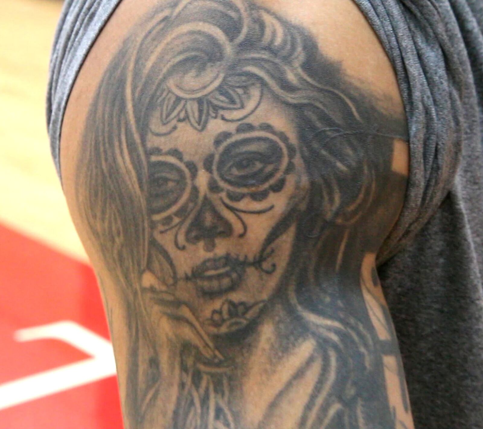 UD Flyers shooting guard Kyle Davis tells his life story through the tattoos he wears. A “Day of the Dead” tattoo represents people in his life that he has lost, Davis says. TY GREENLEES / STAFF
