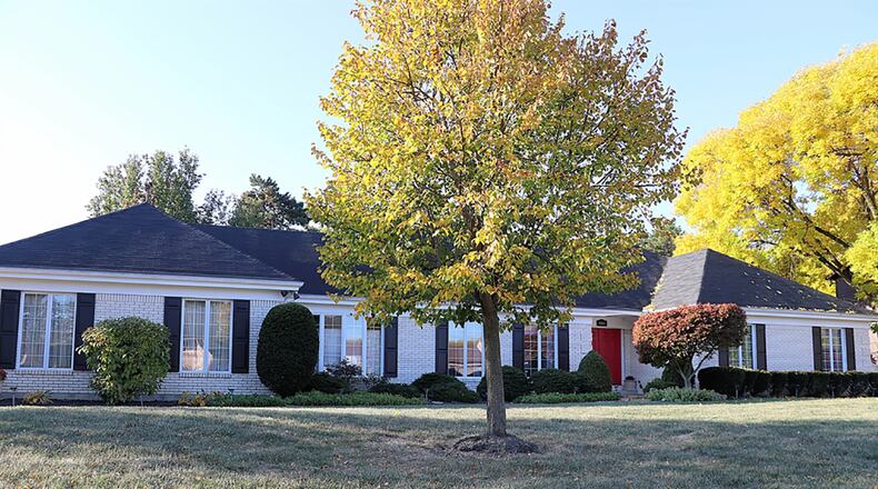 The brick ranch has about 3,240 sq. ft. of living space plus the finished basement. The 4-bedroom home sits on an irregular lot with elevated gardens, mature trees, a covered rear patio and a 2-car, side-entry garage. CONTRIBUTED PHOTO BY KATHY TYLER