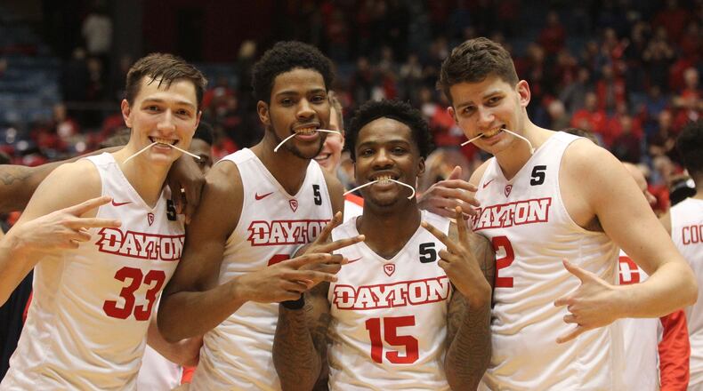 Dayton sophomores Ryan Mikesell, Xeyrius Williams, John Crosby and Sam Miller pose for a photo after a victory against Virginia Commonwealth on Wednesday, March 1, 2017, at UD Arena. David Jablonski/Staff