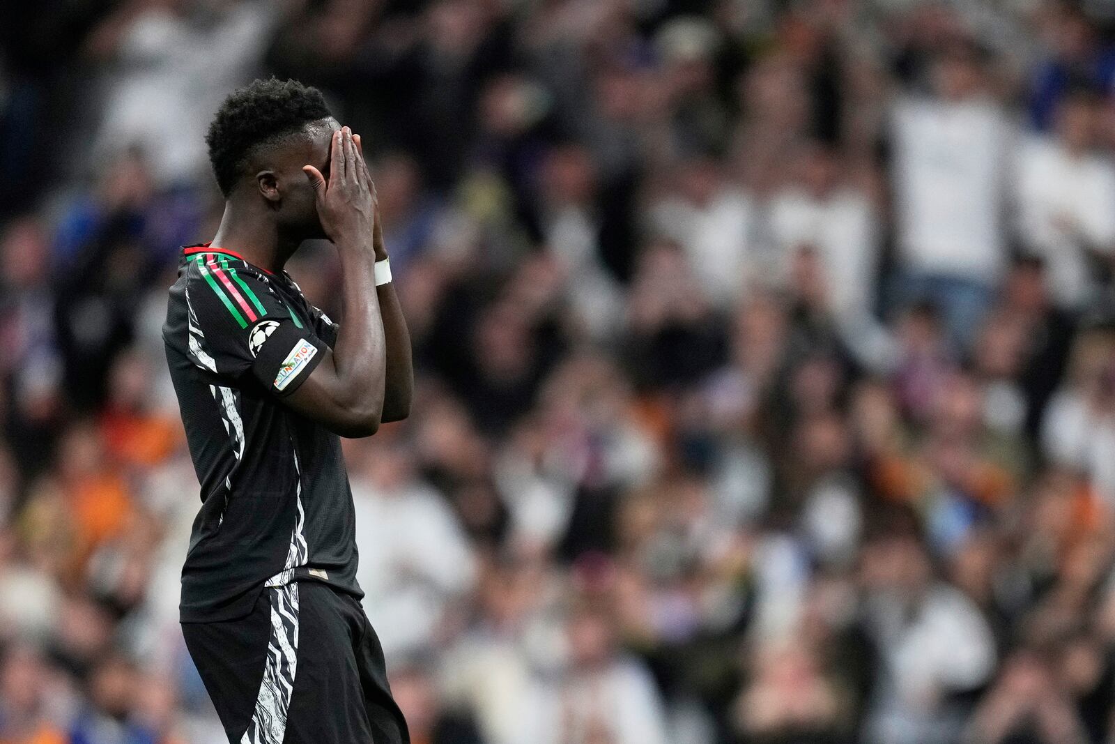 Arsenal's Bukayo Saka reacts after missing a chance to score during the Champions League quarterfinals second leg soccer match between Real Madrid and Arsenal at the Santiago Bernabeu stadium in Madrid, Wednesday, April 16, 2025. (AP Photo/Bernat Armangue)