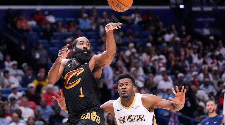 Cleveland Cavaliers guard James Harden (1) passes around New Orleans Pelicans center Yves Missi in the first half of an NBA basketball game, Saturday, March 21, 2026, in New Orleans. (AP Photo/Gerald Herbert)