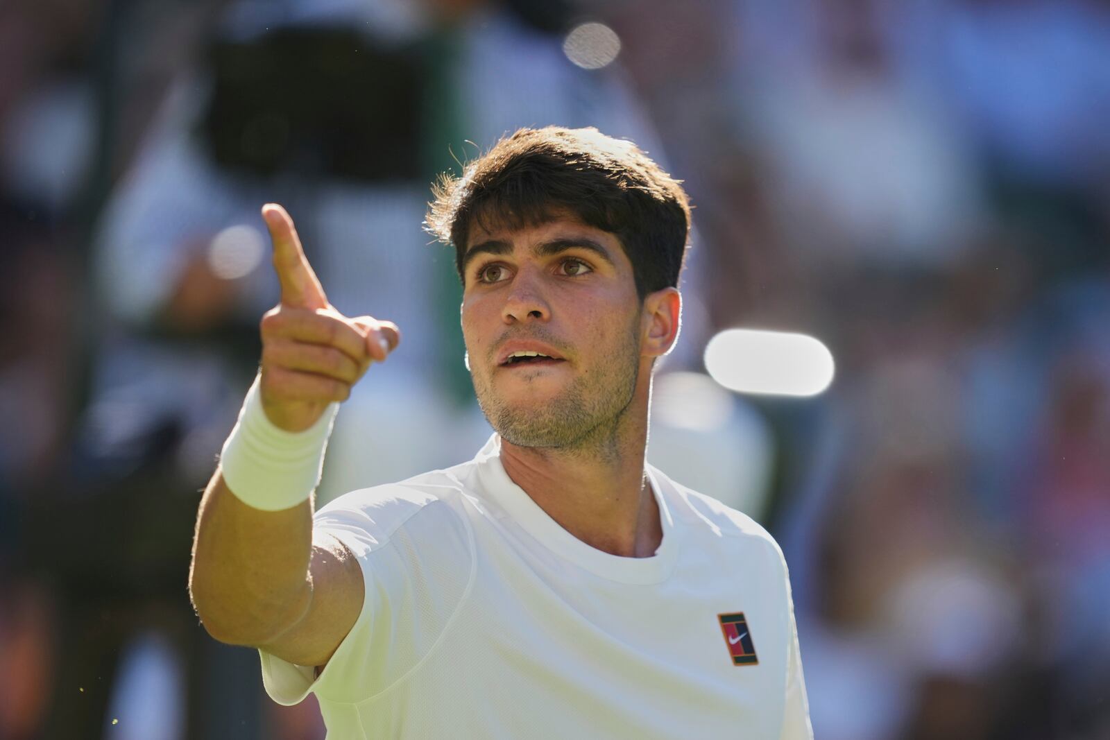 Carlos Alcaraz of Spain reacts after breaking the serve of Fabio Fognini of Italy during their first round men's singles match at the Wimbledon Tennis Championships in London, Monday, June 30, 2025. (AP Photo/Alastair Grant)