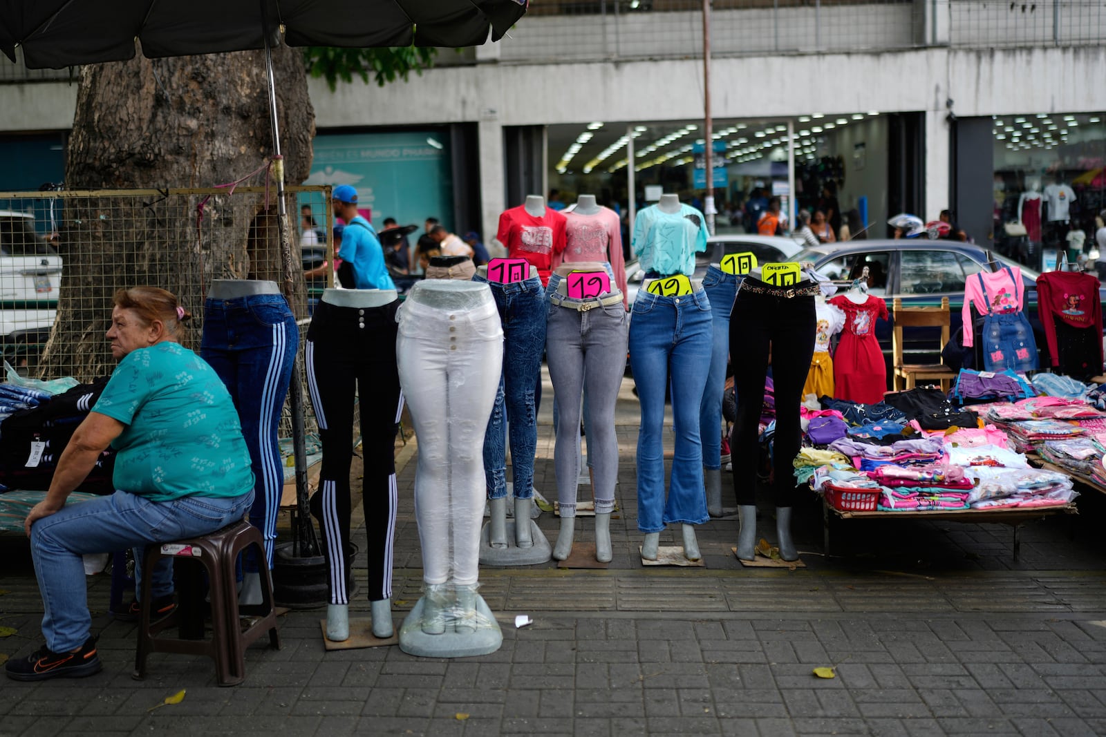 Pants stand on display on a street in Caracas, Venezuela, Thursday, April 10, 2025. (AP Photo/Ariana Cubillos)