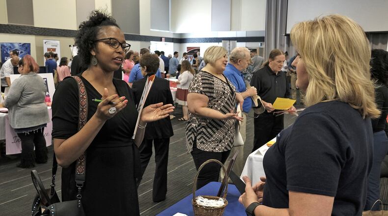 This file photo shows an exchange at a job fair held in Clark County in 2017. A virtual career fair will be held this month and will be centered around companies in Clark and Greene counties. Bill Lackey/Staff