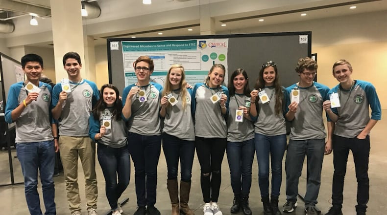 The Air Force Research Laboratory-Carroll High School iGEM team displays their gold medals after the international iGEM competition in Boston Nov. 13. (U.S. Air Force photo/Richard Eldridge)