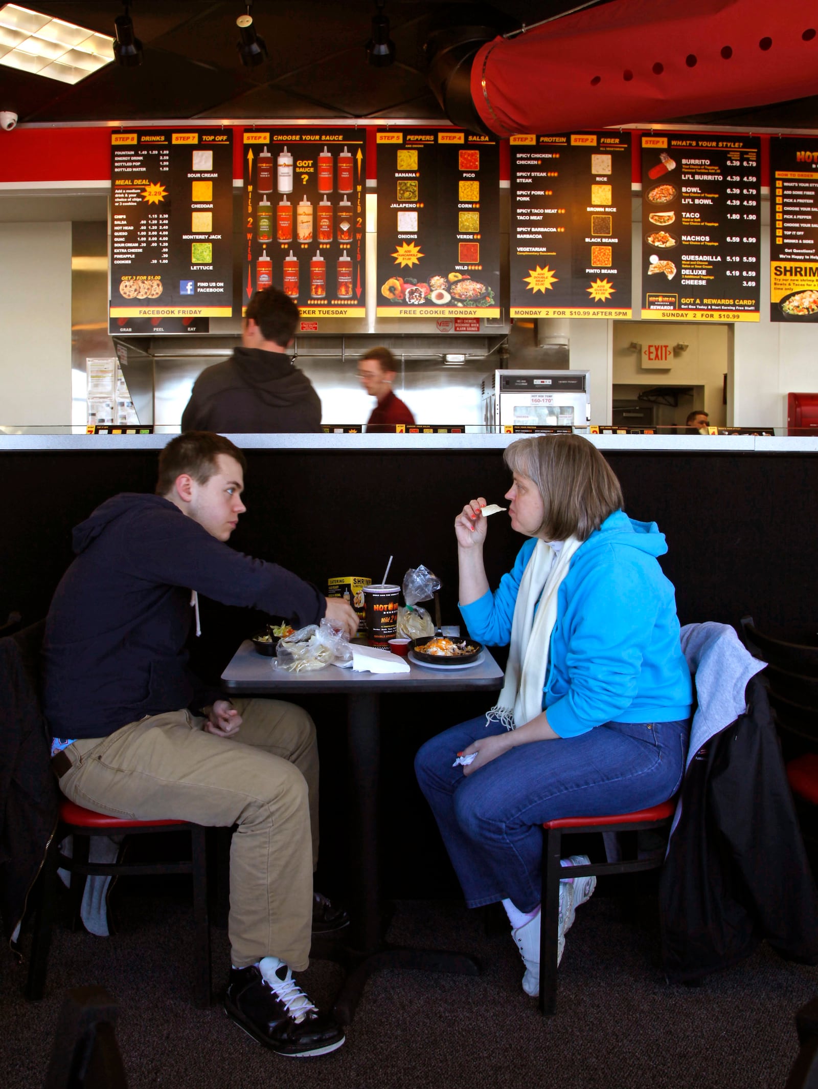 Cody Boothe has lunch with his mom, Cara Boothe, in the 1120 E. Stroop Rd. location of Hot Head Burritos.   TY GREENLEES / STAFF