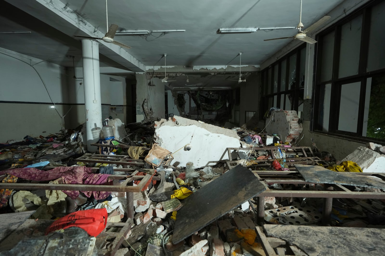 Inside view of a canteen building where the tail of the airplane stuck at the site of an airplane that crashed in India's northwestern city of Ahmedabad in Gujarat state, India, Thursday, June 12, 2025. (AP Photo/Ajit Solanki)