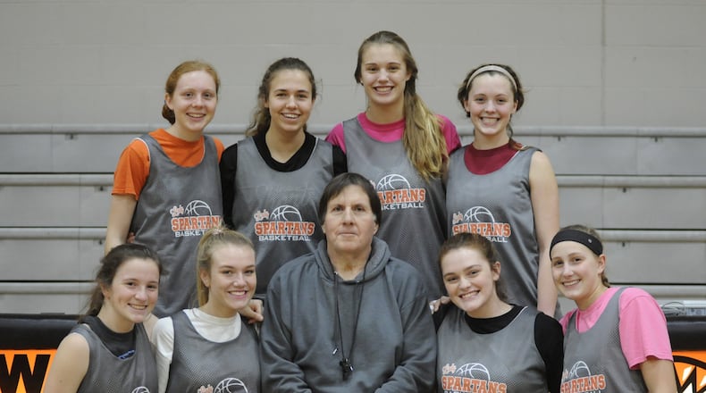 Tim Gabbard is in his 39th season coaching the Waynesville High School girls basketball team. Key members of the unbeaten Spartans are, front (left) Hannah Gill, Carli Brown, Gabbard, Kenzie Purkey and Leah Butterbaugh. Back (left) Kenna Harvey, Lynzie Hartshorn, Marcella Sizer and Rachel Murray. MARC PENDLETON / STAFF