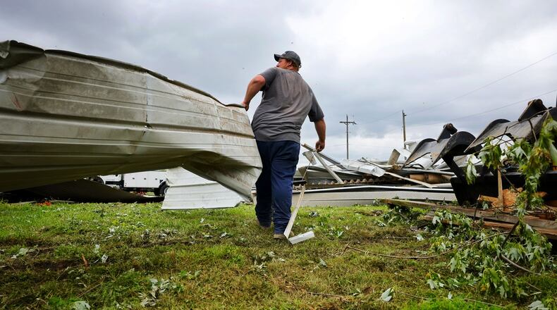 Andy Stang cleans up around a farm on Stillwell Beckett Road in Reily Twp. two days after a tornado Thursday, May 9, 2024. NICK GRAHAM/STAFF