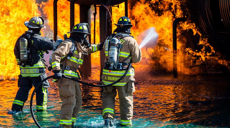 Firefighters from the 788th Civil Engineer Squadron fire department and Dayton Airport fire department spray a fire on an aircraft training fuselage at Wright-Patterson Air Force Base April 26. Crews from the 788th CES fire department train twice a year to ensure their skills are always up to date. U.S. AIR FORCE PHOTO/WESLEY FARNSWORTH