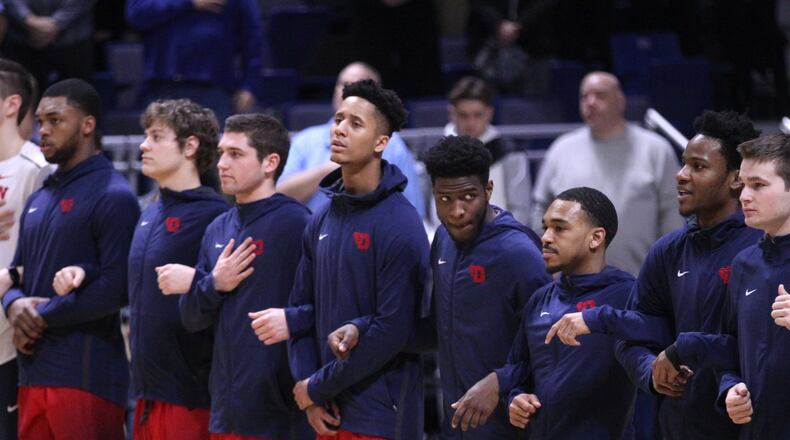 Dayton players stand for the national anthem before a game against Rhode Island on Friday, Feb. 23, 2018, at the Ryan Center in Kingston, R.I. David Jablonski/Staff