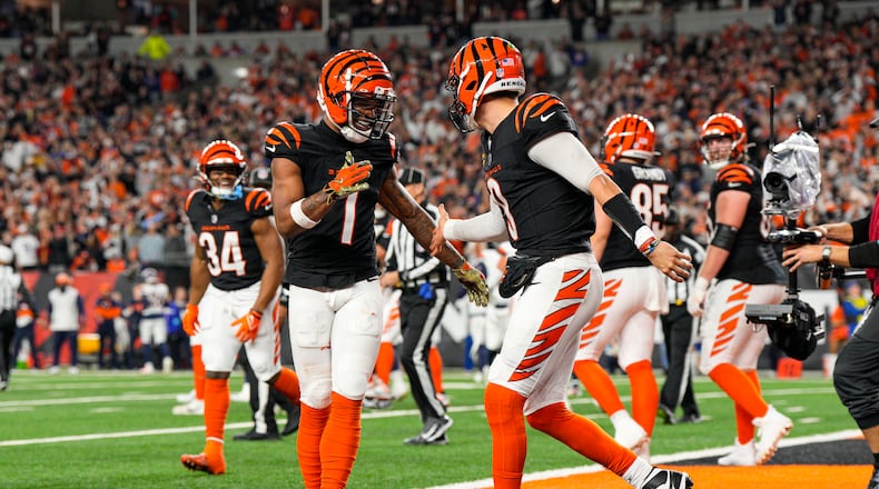 Cincinnati Bengals quarterback Joe Burrow (9) celebrates with wide receiver Ja'Marr Chase (1) after a touchdown against the Denver Broncos during the second half of an NFL football game in Cincinnati, Saturday, Dec. 28, 2024. (AP Photo/Jeff Dean)