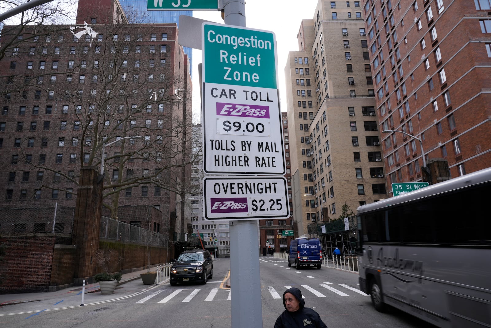 FILE - Signs advising drivers of congestion pricing tolls are displayed near the exit of the Lincoln Tunnel in New York, Wednesday, Feb. 19, 2025. (AP Photo/Seth Wenig, File)