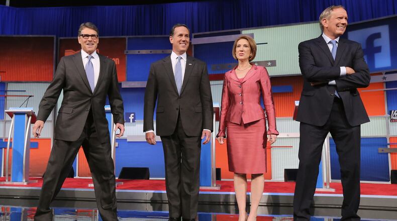 CLEVELAND, OH - AUGUST 06: Republican presidential candidates (L-R) Rick Perry, Rick Santorum, Carly Fiorina and George Pataki take the stage for a presidential pre-debate forum hosted by FOX News and Facebook at the Quicken Loans Arena August 6, 2015 in Cleveland, Ohio. Seven GOP candidates were selected to participate in the forum based on their rank in an average of the five most recent national political polls. (Photo by Chip Somodevilla/Getty Images)