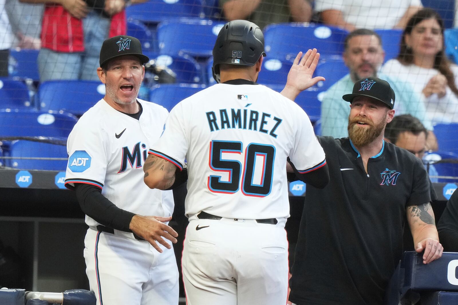 Miami Marlins' Agustin Ramirez (50) is congratulated after scoring on a single hit by Ronny Simon during the second inning of a baseball game against the Cincinnati Reds, Monday, April 21, 2025, in Miami. (AP Photo/Lynne Sladky)