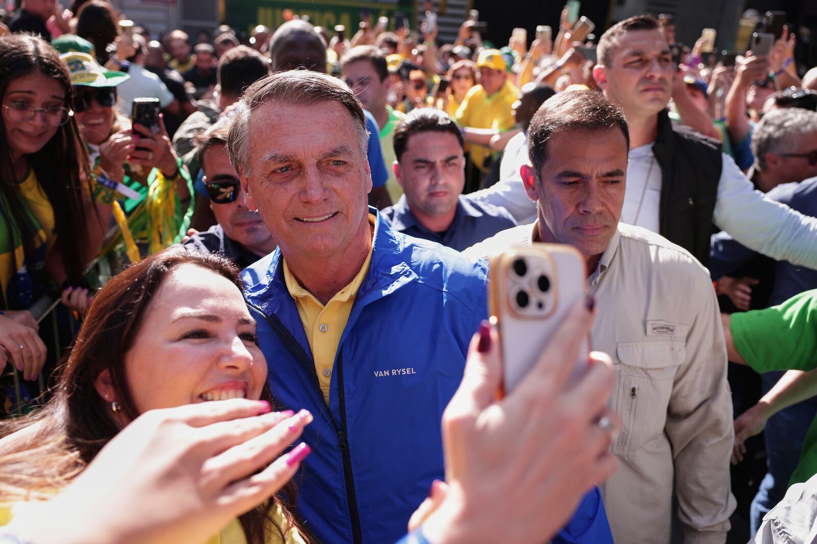 Former President Jair Bolsonaro poses for a selfie with a supporter upon arriving at a protest against his Supreme Court trial, in which he is accused of involvement in a 2022 coup attempt, in Sao Paulo, Sunday, June, 29, 2025. (AP Photo/Ettore Chiereguini)