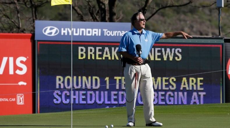 FILE - This Jan. 6, 2013, file photo shows broadcast analyst Mark Rolfing talking about the wind from the 10th green before the first round at the Tournament of Champions PGA golf tournament, in Kapalua, Hawaii. Five months after he was diagnosed with a rare form of cancer, Mark Rolfing returns to his broadcasting duties for Golf Channel on Jan. 7 for the Hyundai Tournament of Champions in Hawaii. (AP Photo/Elaine Thompson, File)