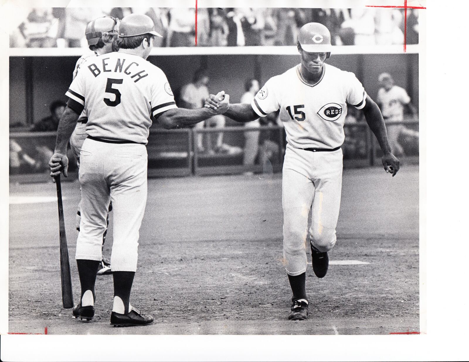 Johnny Bench greets George Foster at home plate.