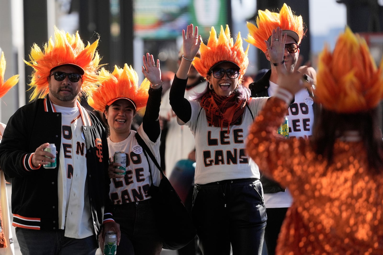 Fans of San Francisco Giants' Jung Hoo Lee, who call themselves Hoo Lee Gans, greet fellow fans as they arrive before a baseball game between the Giants and the Arizona Diamondbacks in San Francisco, Tuesday, May 13, 2025. (AP Photo/Jeff Chiu)