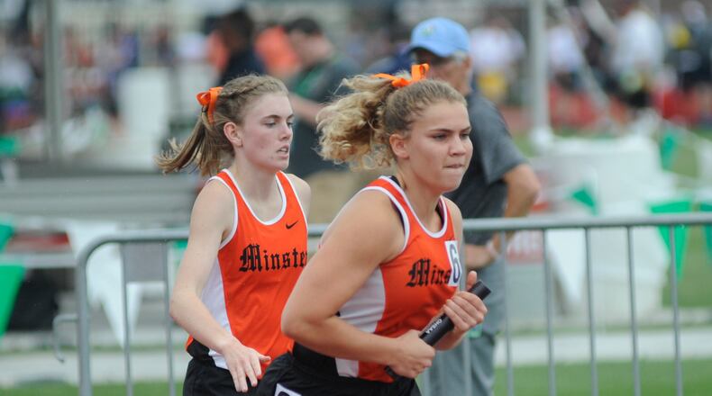 Minster anchor Madeline Magoto (right) gets the baton from Emma Watcke. MARC PENDLETON / STAFF