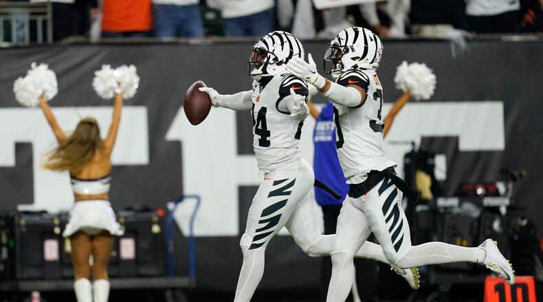 Cincinnati Bengals' Vonn Bell (24) celebrates an interception with Jessie Bates III (30) during the first half of an NFL football game against the Miami Dolphins, Thursday, Sept. 29, 2022, in Cincinnati. (AP Photo/Joshua A. Bickel)