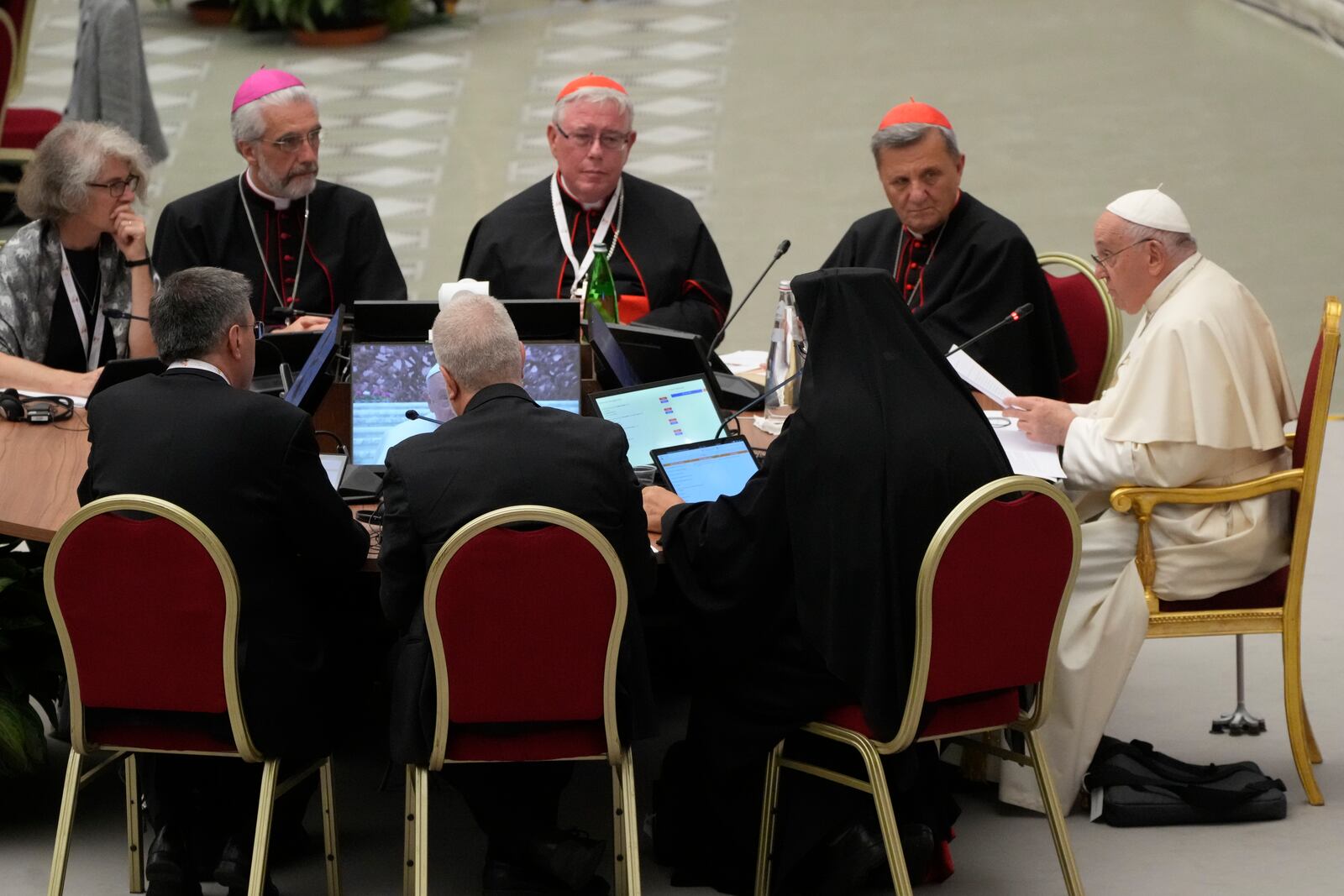 FILE - From left front to camera, Sister Nathalie Becquart, Undersecretary of the Synod of Bishops Luis Marín de San Martín, Synod's Rapporteur Cardinal Jean-Claude Hollerich, and Synod of Bishops' Secretary General Cardinal Mario Grech, listen to Pope Francis, right, during the opening session of the 16th General Assembly of the Synod of Bishops in the Paul VI Hall at The Vatican, Wednesday, Oct. 4, 2023. (AP Photo/Gregorio Borgia, file)