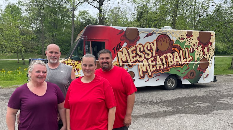 Pictured left to right are Crystal Moberly, Donnie Moberly, Angela Ashburn and Jeremy Vanmeter, who operate The Messy Meatball and DC's Burgers & More food trucks. NATALIE JONES/STAFF